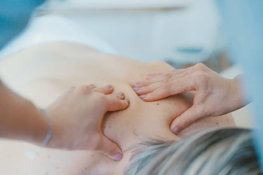 A close-up of a person receiving a back massage.